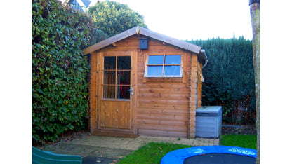 Compact houten Interflex 2520 tuinhuis naast trampoline in groene tuin met beplanting